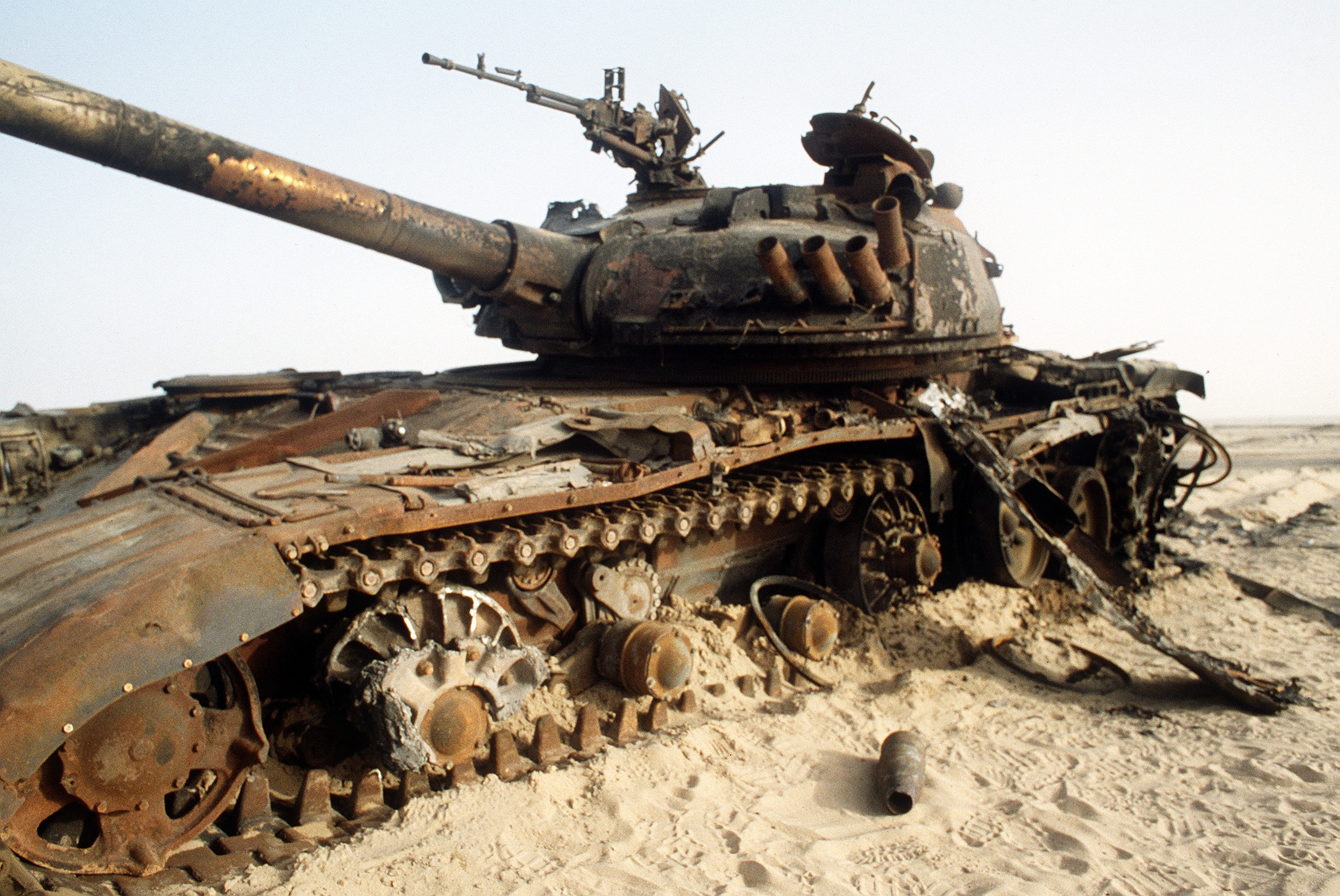 A destroyed Iraqi T-72 main battle tank sits in the desert in the wake of advancing coalition forces during Operation Desert Storm.