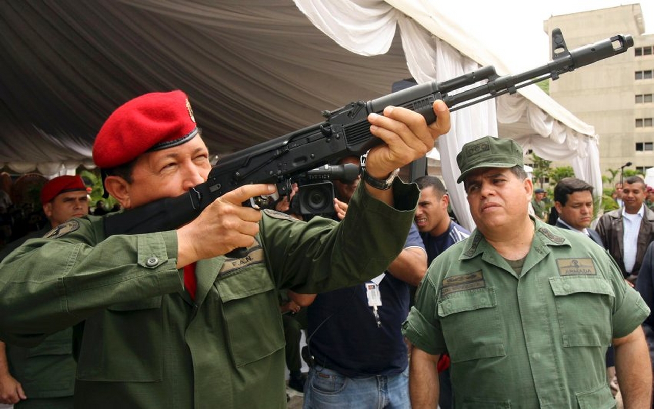 Venezuelan President Hugo Chavez holds a new AK-103 Russian Kalashnikov assault rifle next to Defense Minister Orlando Maniglia (R) during an special ceremony at the current Expo Ejercito (Expo Army) 2006 exhibition in Caracas, in this June 14, 2006 file photo. President Hugo Chavez marked 10 years in office on Monday February 2, 2009, declaring a national holiday to celebrate just hours before the anniversary in a sign of how personalized his grip on Venezuela has become. REUTERS/Miraflores Palace/Handout/Files (VENEZUELA). FOR EDITORIAL USE ONLY. NOT FOR SALE FOR MARKETING OR ADVERTISING CAMPAIGNS.