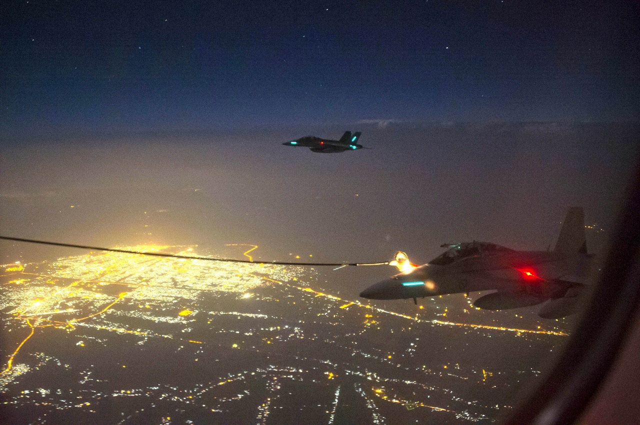 A handout photo taken October 5, 2014 and obtained on October 9 shows two Royal Australian Air Force (RAAF) F/A-18F Super Hornet aircraft refuelling from a RAAF KC-30A Multi Role Tanker Transport aircraft above a city in Iraq. A Super Hornet fighter jet has carried out Australia's first bombing raid in Iraq, targeting what the defence ministry on October 9, 2014, described as a "facility" of the Islamist State group. AFP PHOTO/HO/AUSTRALIAN DEFENCE/SERGEANT HAMISH PATERSON ----EDITORS NOTE ----RESTRICTED TO EDITORIAL USE MANDATORY CREDIT " AFP PHOTO / AUSTRALIAN DEFENCE/SERGEANT HAMISH PATERSON" NO MARKETING NO ADVERTISING CAMPAIGNS - DISTRIBUTED AS A SERVICE TO CLIENTS