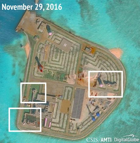 A satellite image shows what CSIS Asia Maritime Transparency Initiative says appears to be anti-aircraft guns and what are likely to be close-in weapons systems (CIWS) on the artificial island Johnson Reef in the South China Sea in this image released on December 13, 2016. Courtesy CSIS Asia Maritime Transparency Initiative/DigitalGlobe/Handout via REUTERS