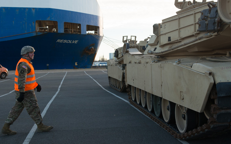 epa05701359 An US soldier walks to a US Army tank in front of the cargo vessel 'Resolve' in Bremerhaven, northern Germany, 06 January 2017. More than 2,500 tanks, trucks and other vehicles of the US Army will be handled in Bremerhaven during what is the biggest troop transfer from the US to Europe since the end of the Soviet Union. The US equipment will be transported to Poland on some 900 railway waggons for the military excercise Atlantic Resolve. EPA/DAVID HECKER EPA/DAVID HECKER