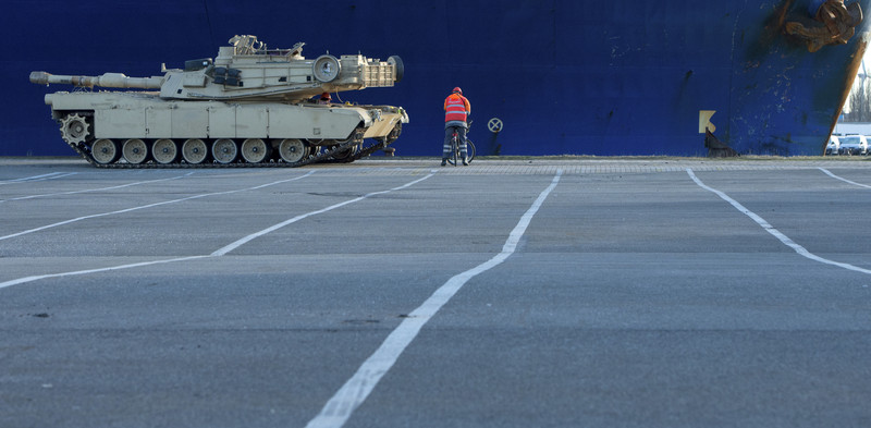 epa05701319 A tank of the US Army has to wait for the so-called 'Checker' on his bike in front of the cargo vessel 'Resolve' in Bremerhaven, northern Germany, 06 January 2017. More than 2,500 tanks, trucks and other vehicles of the US Army will be handled in Bremerhaven during what is the biggest troop transfer from the US to Europe since the end of the Soviet Union. The US equipment will be transported to Poland on some 900 railway waggons for the military excercise Atlantic Resolve. EPA/DAVID HECKER